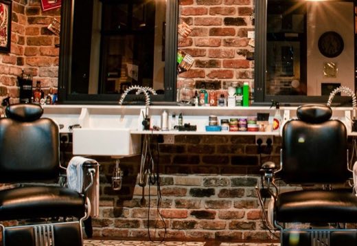 Barber scissors, comb and razor laid out for a grooming ritual